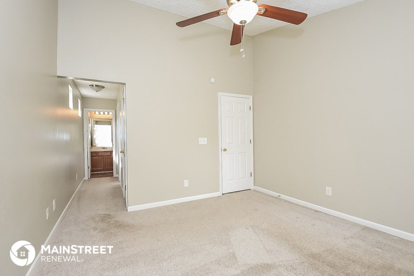 the master bedroom is spacious and has a ceiling fan