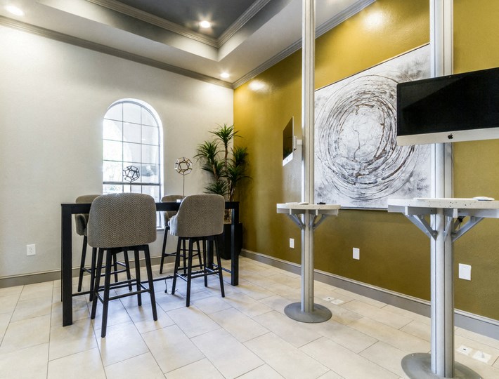 a dining room with a table and chairs and a television