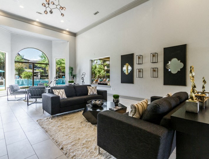 a living room with couches and a table and a large window