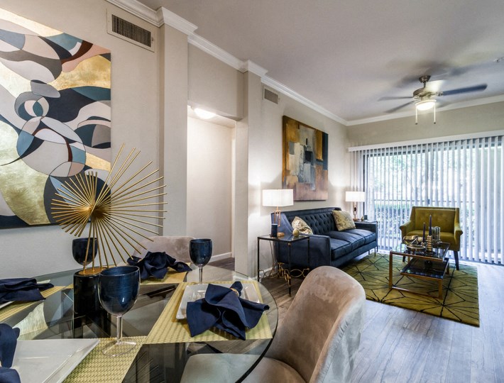 a living room with a glass table and a couch