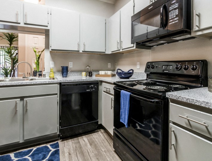 a kitchen with stainless steel appliances and white cabinets