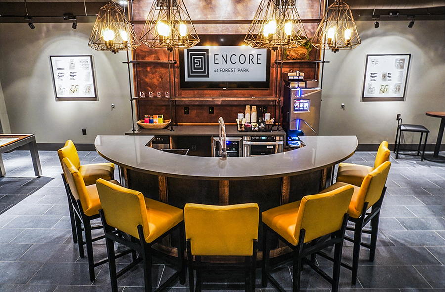 a round bar with yellow chairs in a restaurant