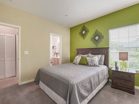 a bedroom with a bed and a green wall