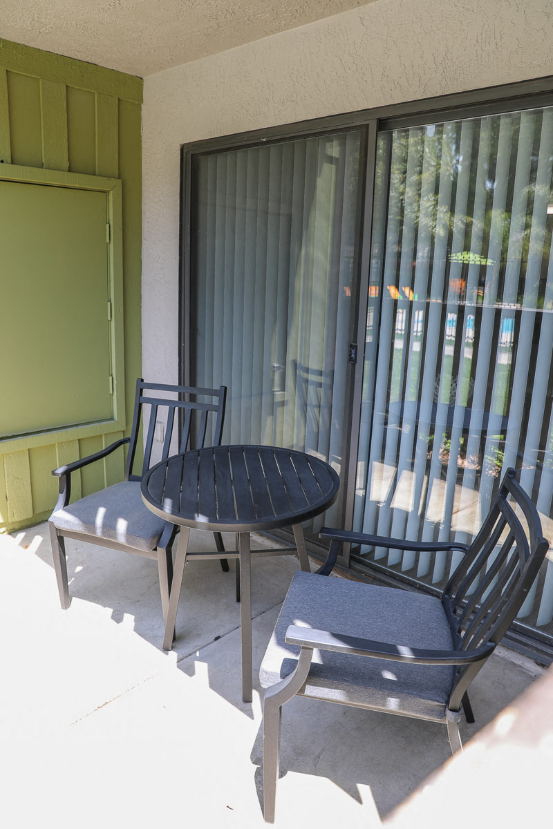 a patio with two chairs and a table
