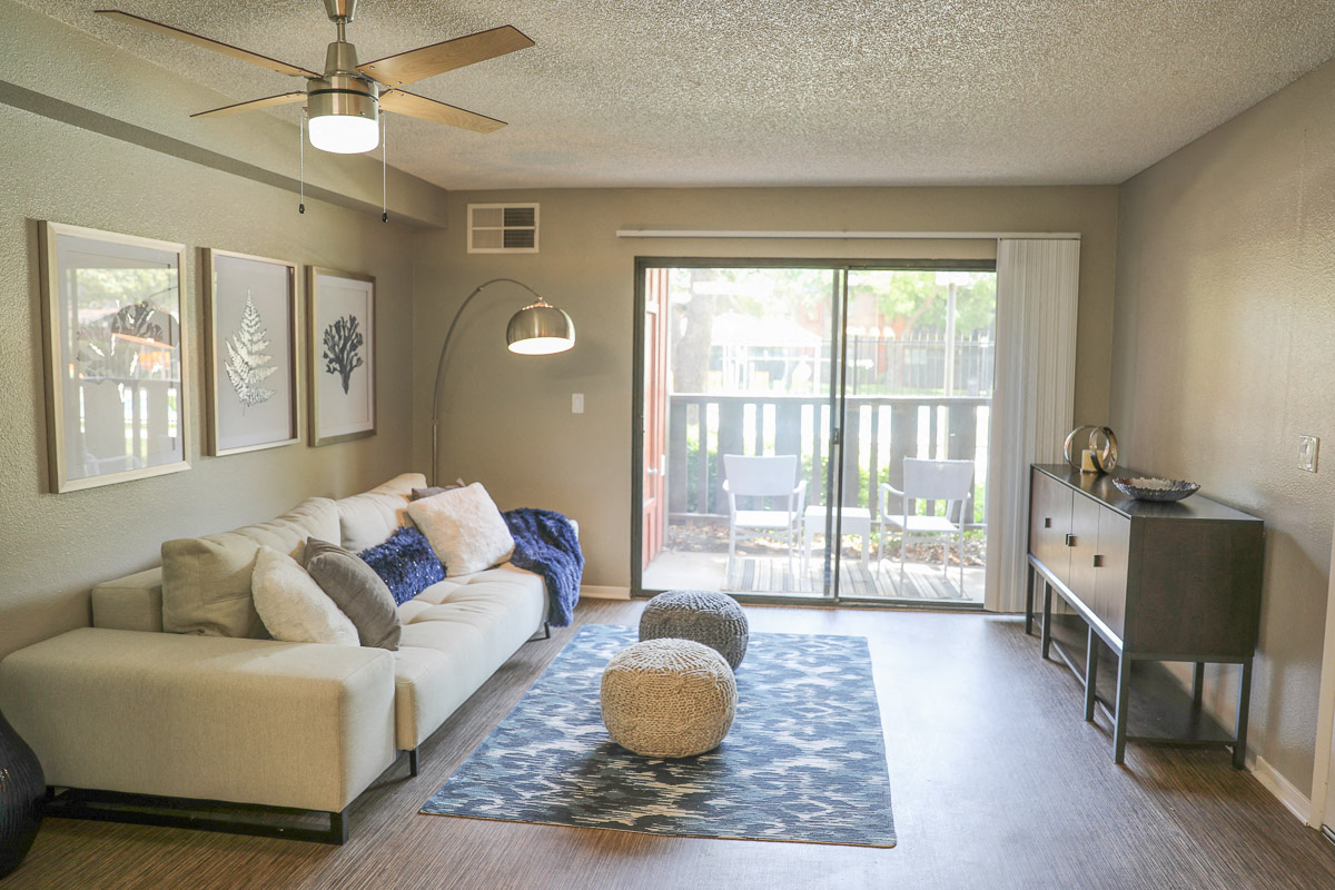 a living room with a white couch and a sliding glass door
