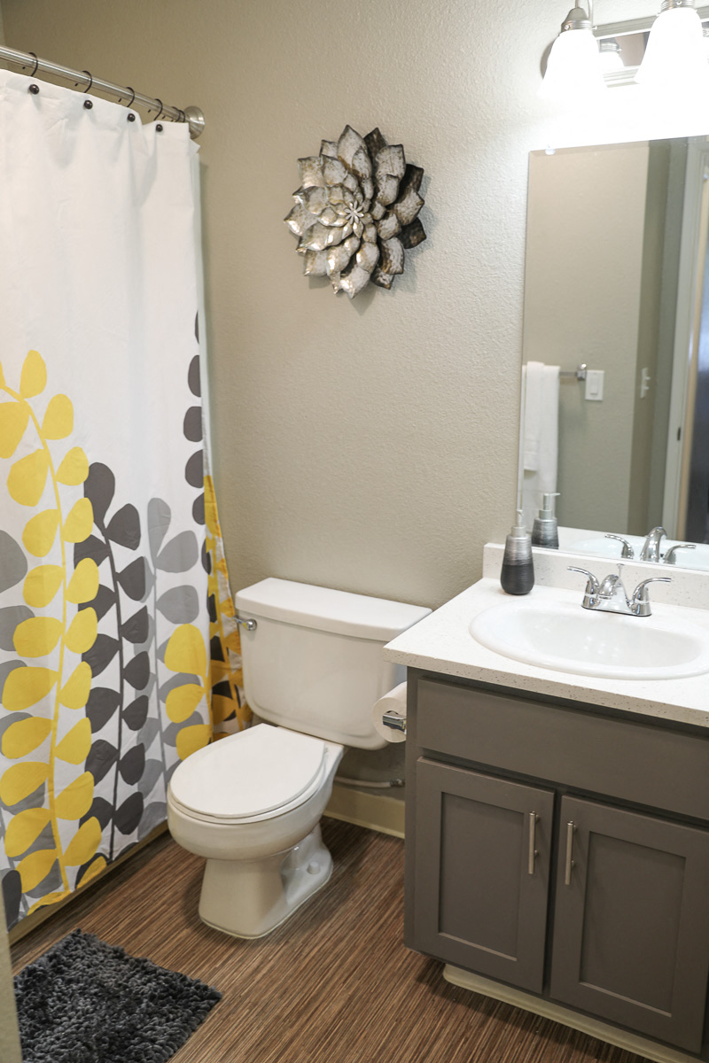 a bathroom with a toilet and a sink and a shower curtain