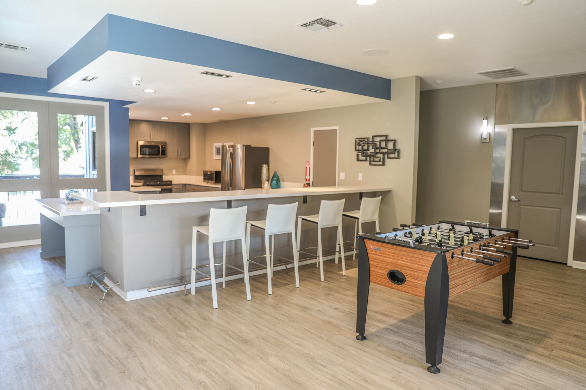 a game room with a foosball table and a bar
