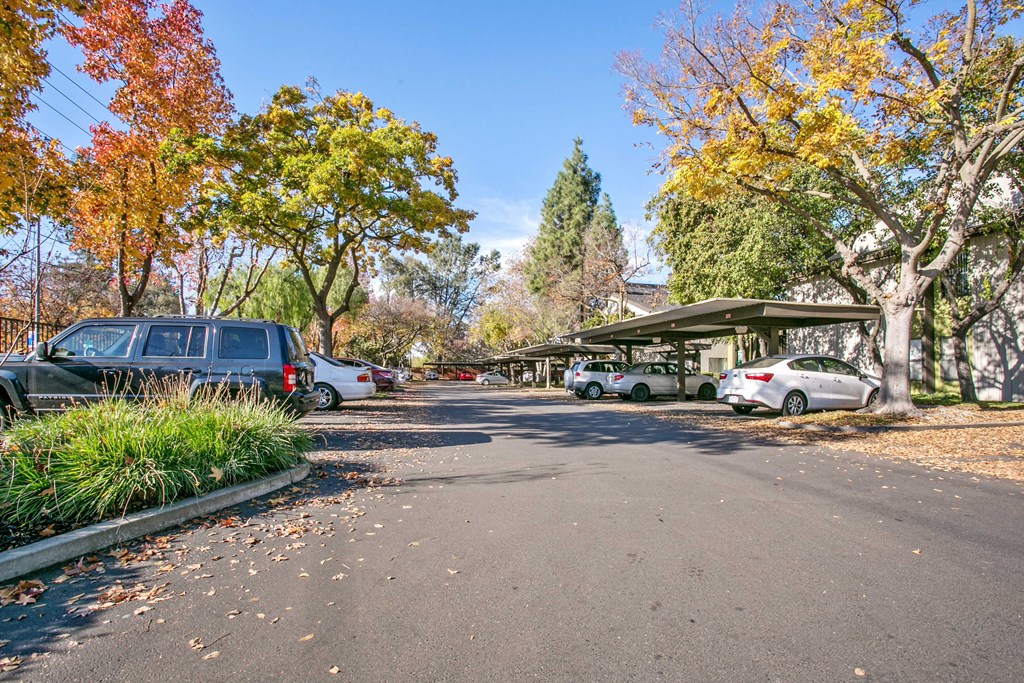 a parking lot with cars parked in front of a building