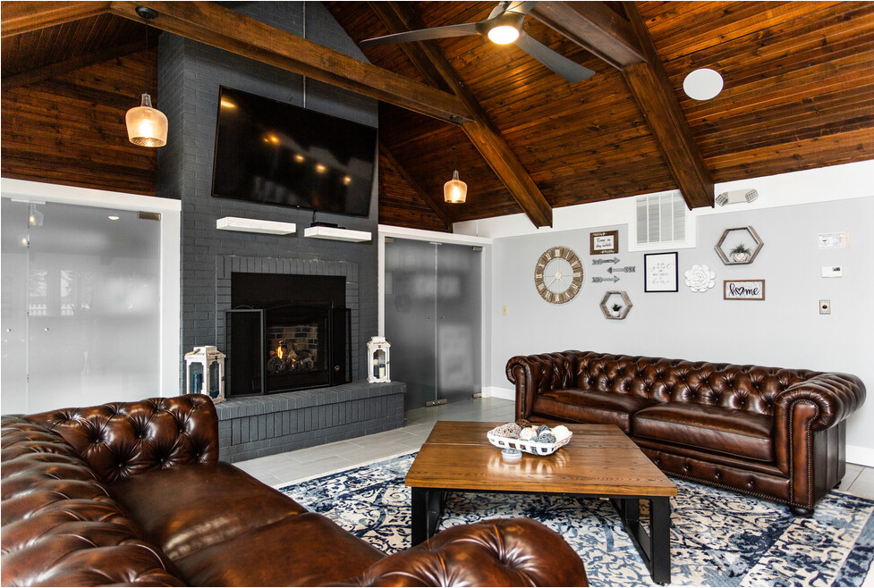 a living room with leather couches and a fireplace