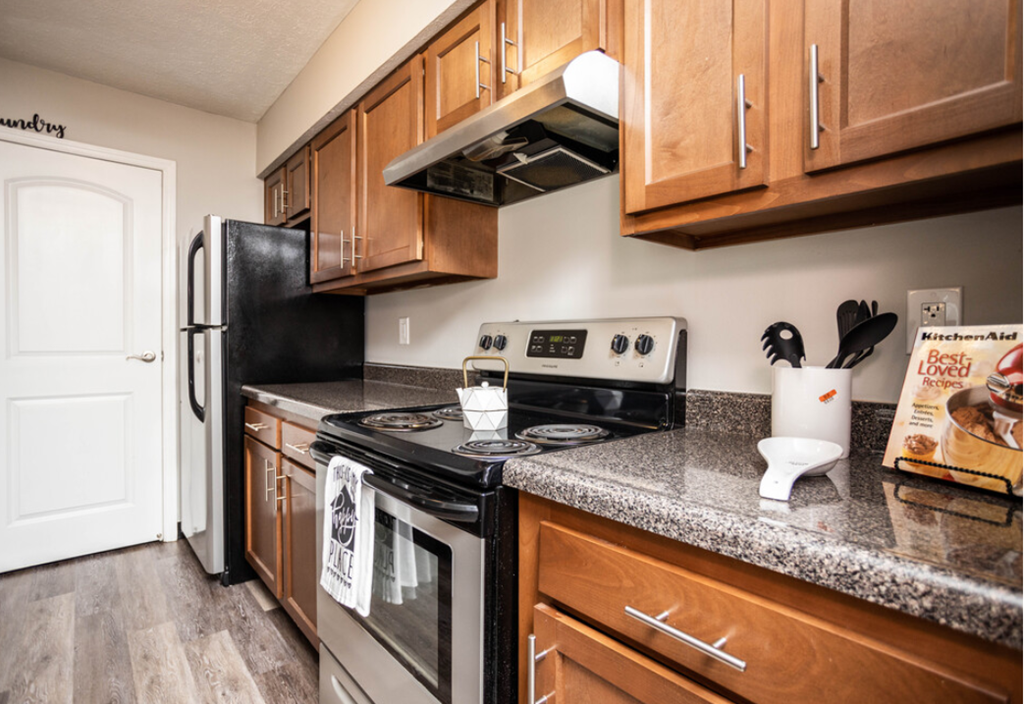 a kitchen with wood cabinets and stainless steel appliances and granite counter tops