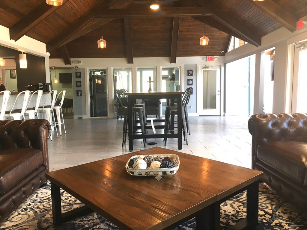 a large room with a table and chairs and a table with food on it