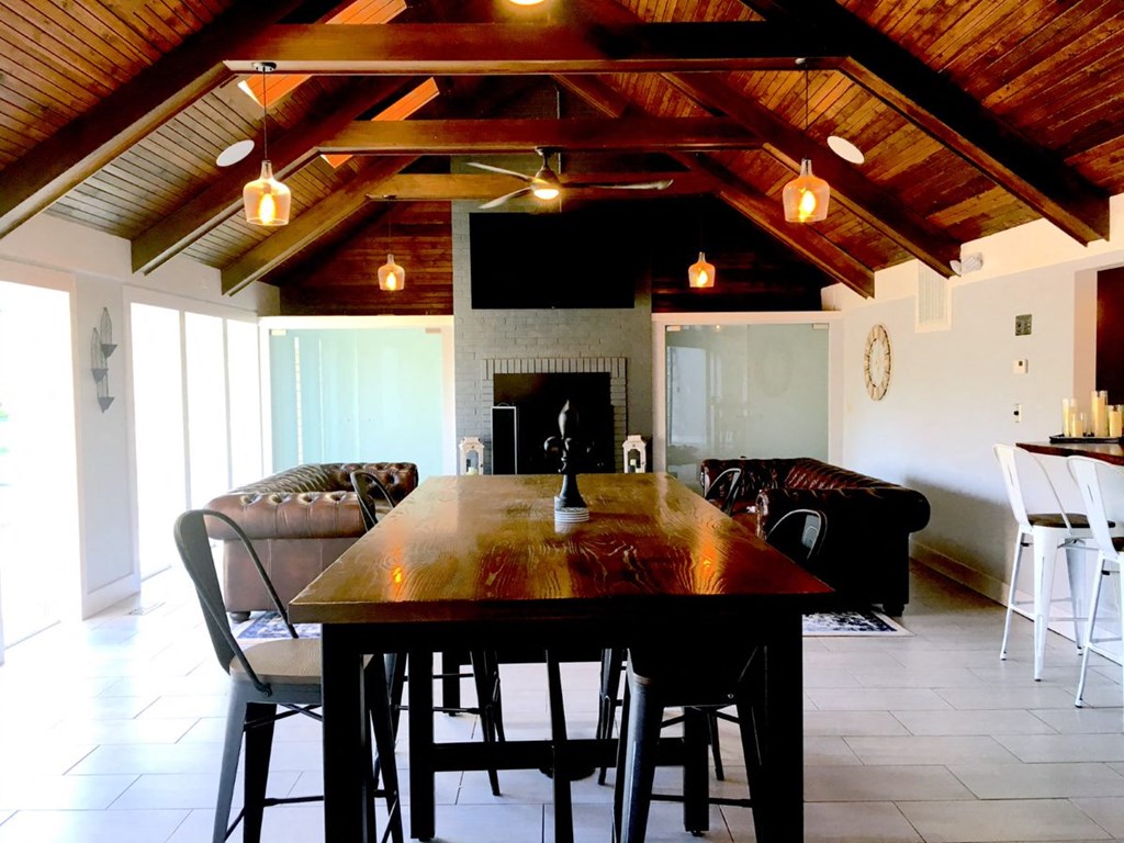 a dining room with a wooden table and a fireplace