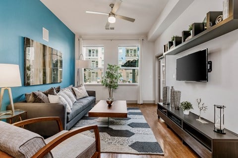 a living room with a blue accent wall and a couch