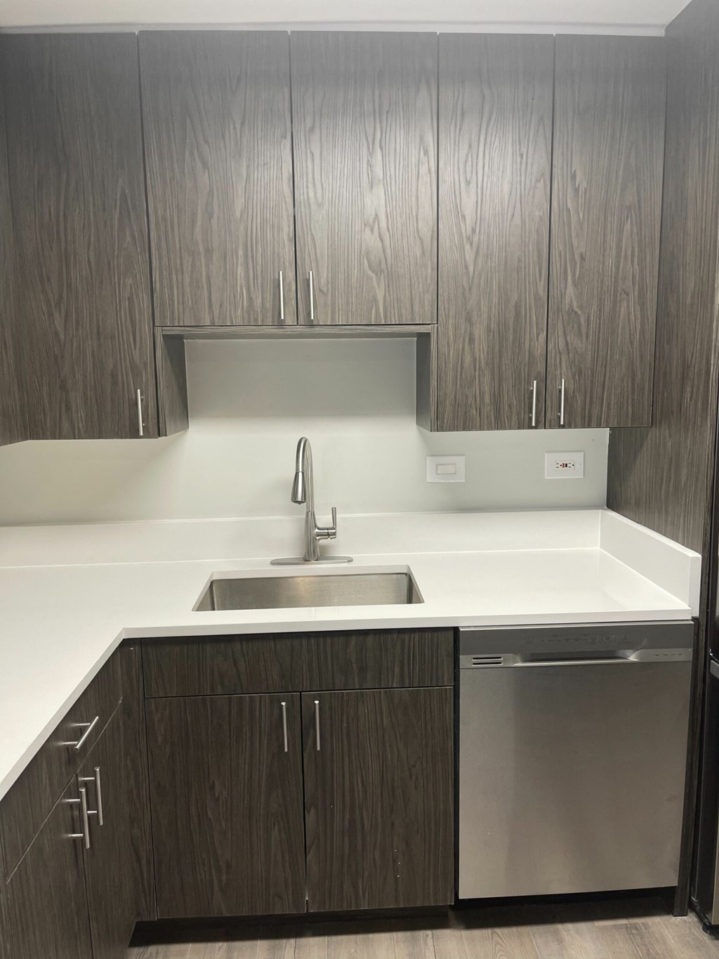 an empty kitchen with a sink and cabinets
