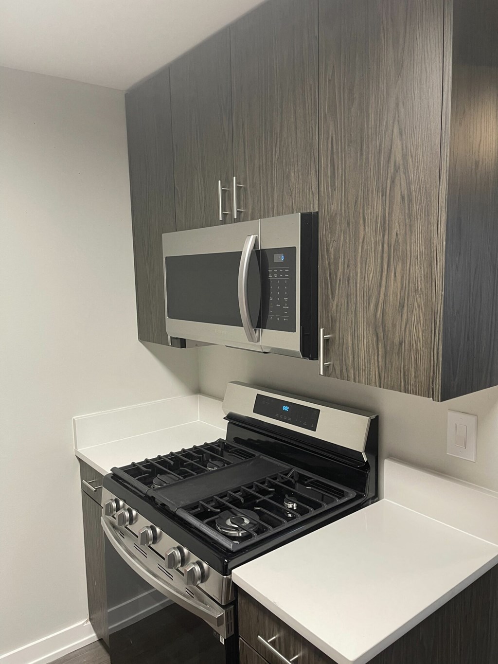 a small kitchen with a stove and a microwave