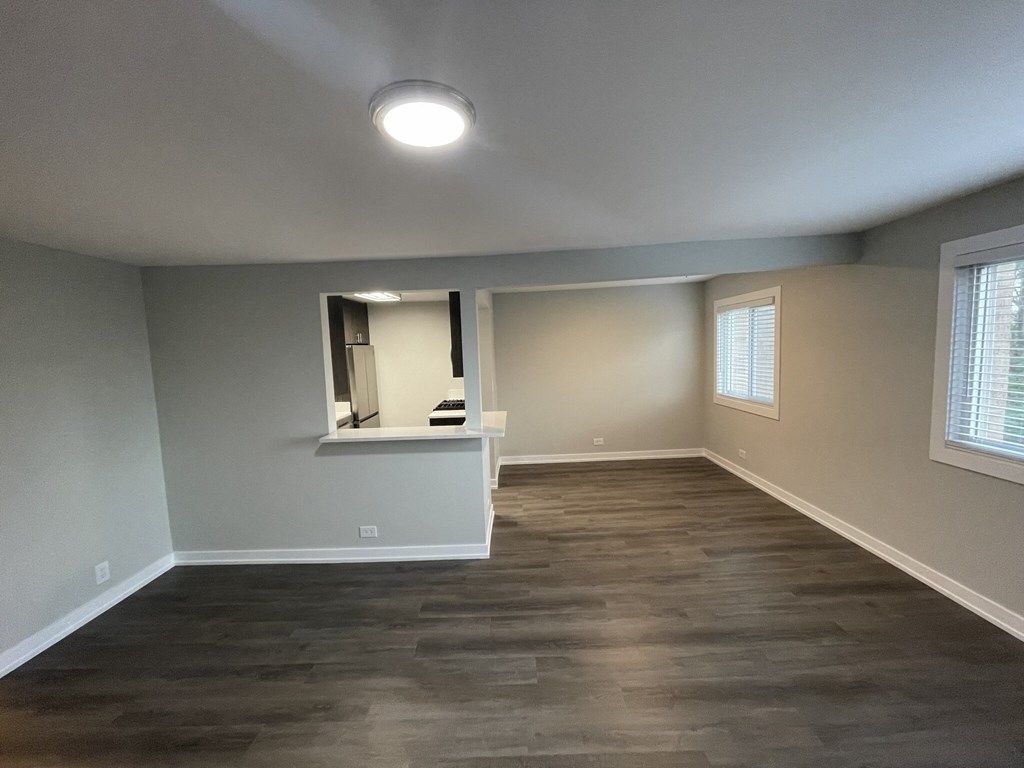 a living room with wood floors and a window