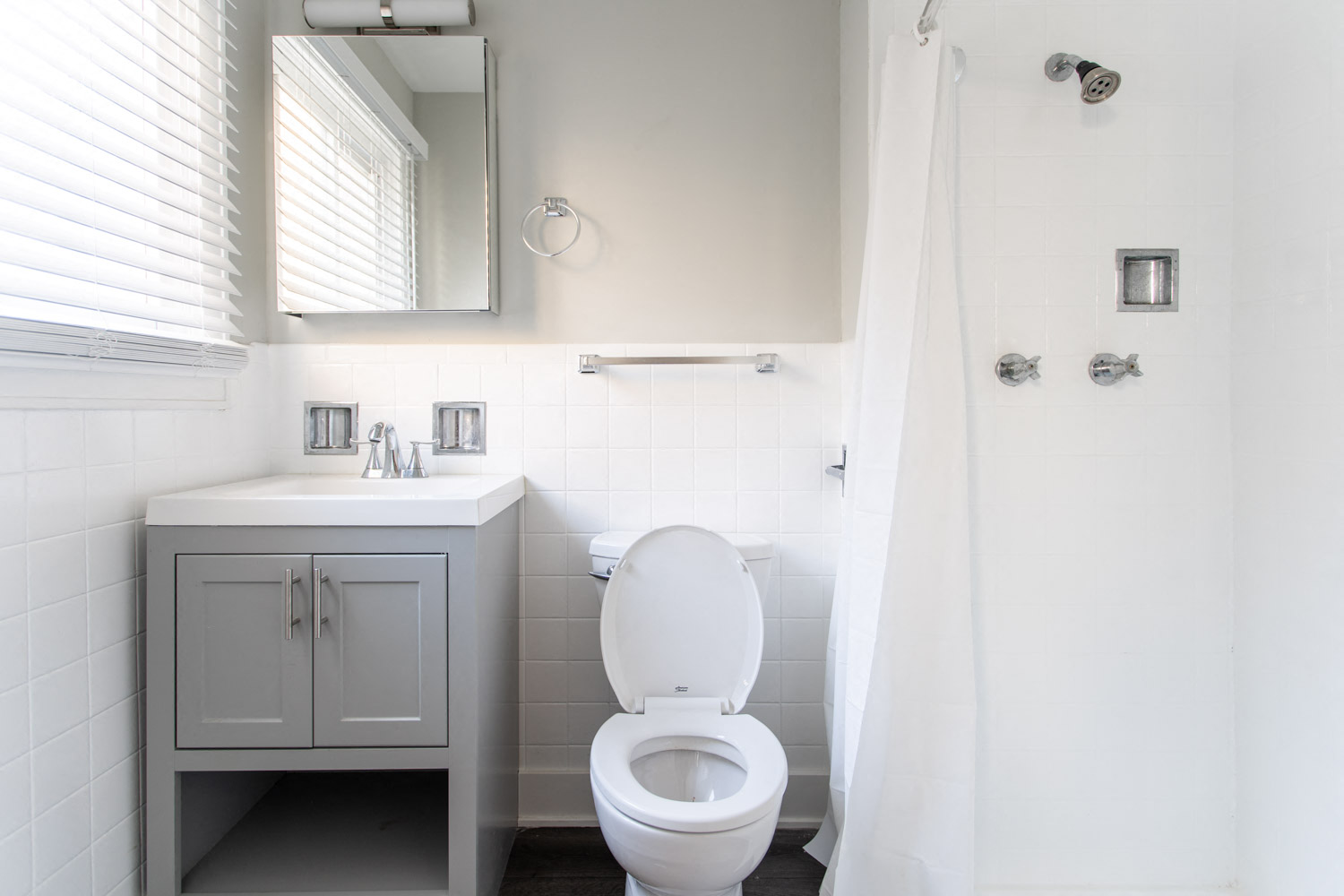 a bathroom with a toilet and a sink and a mirror
