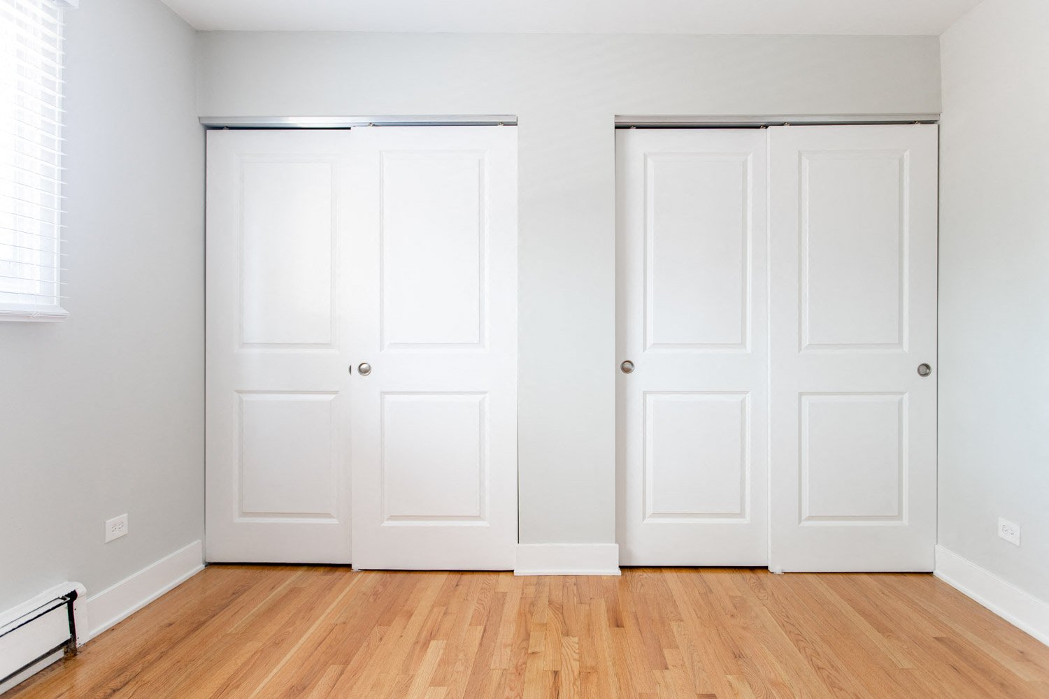 an empty room with two white closet doors