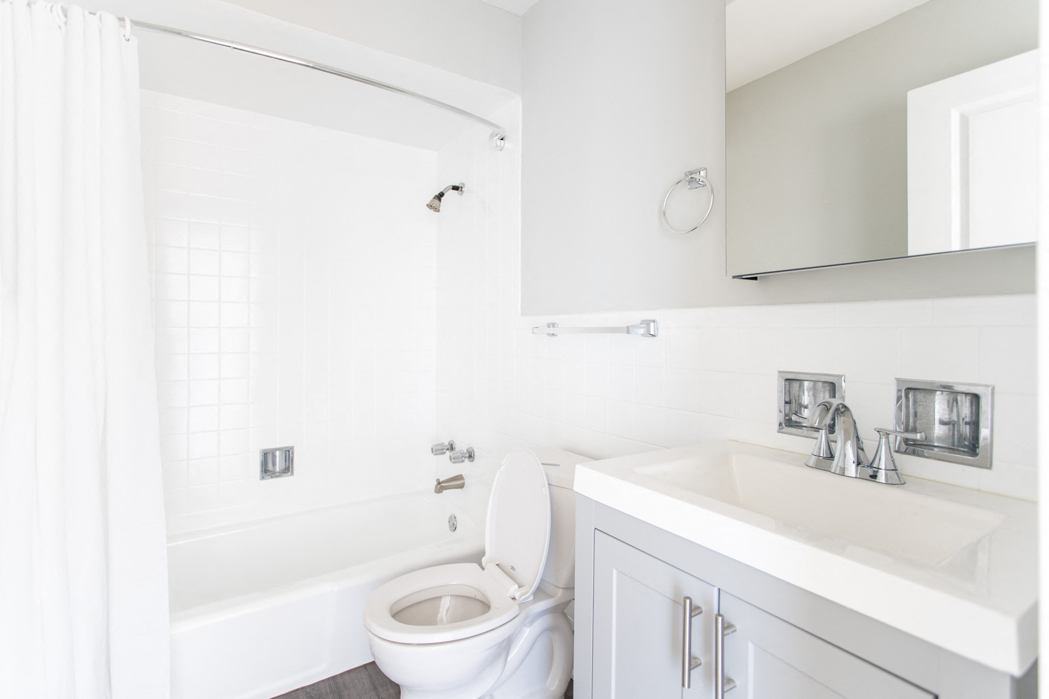 a white bathroom with a toilet and a sink