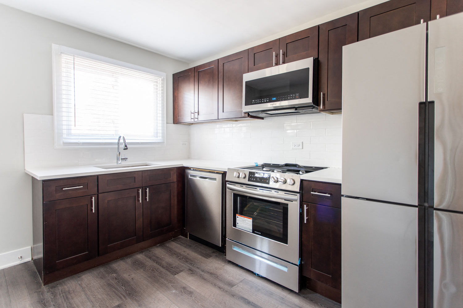 a kitchen with wooden cabinets and stainless steel appliances