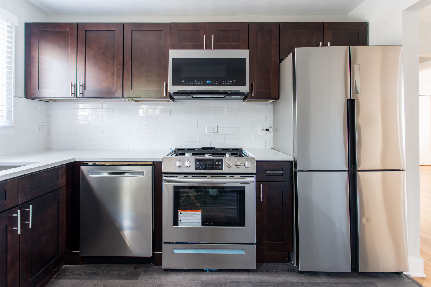 a kitchen with stainless steel appliances and wooden cabinets
