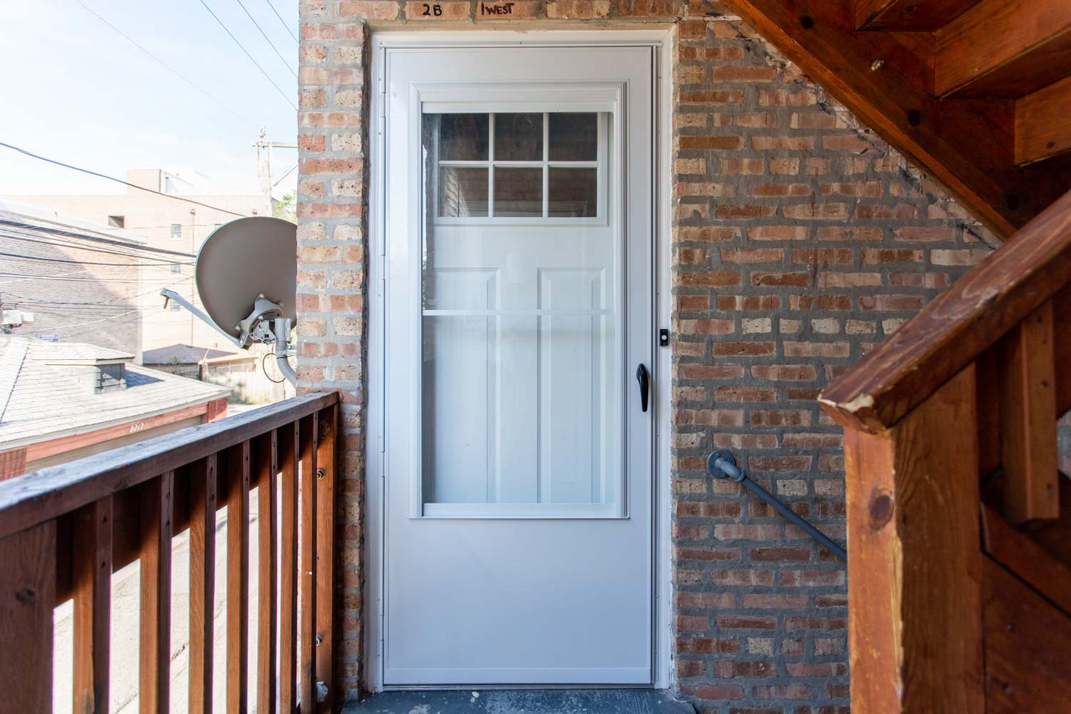 the front door of a brick house with a white door