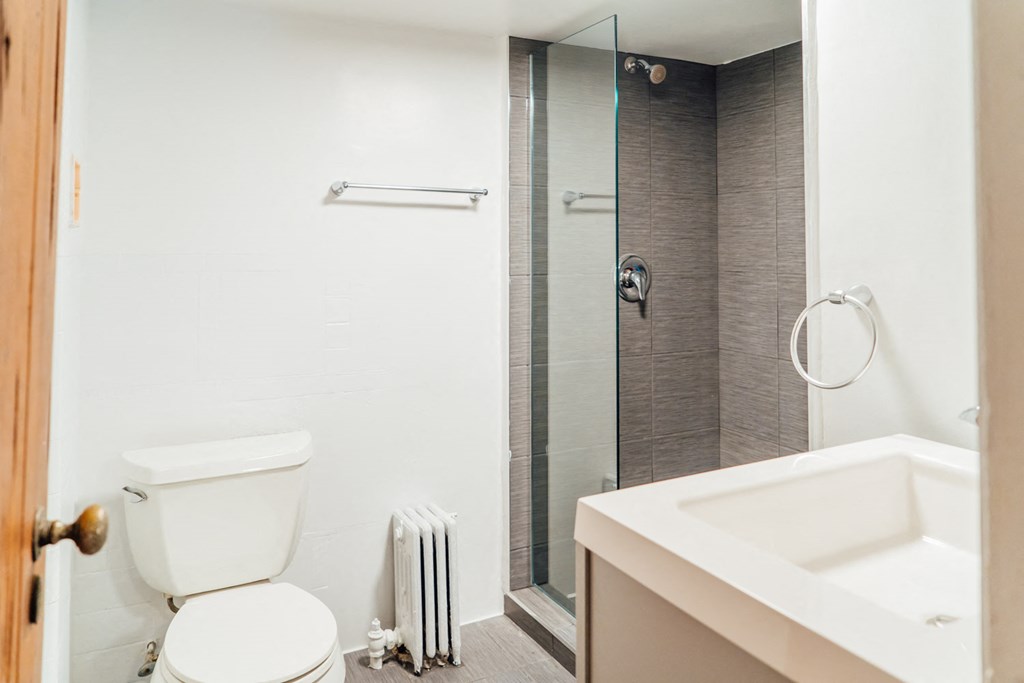 a bathroom with a toilet and a sink and a shower