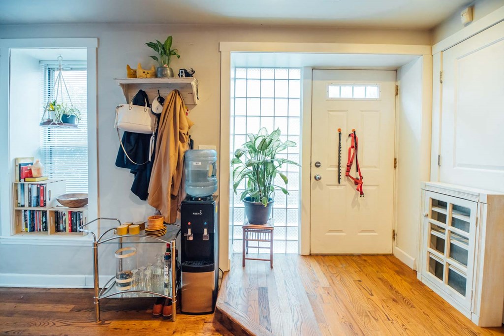 a living room with a white door and a closet