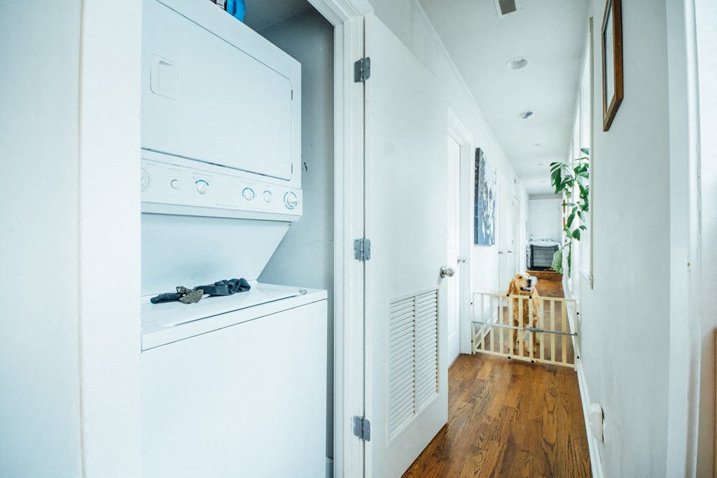 a white kitchen with an oven and a washing machine