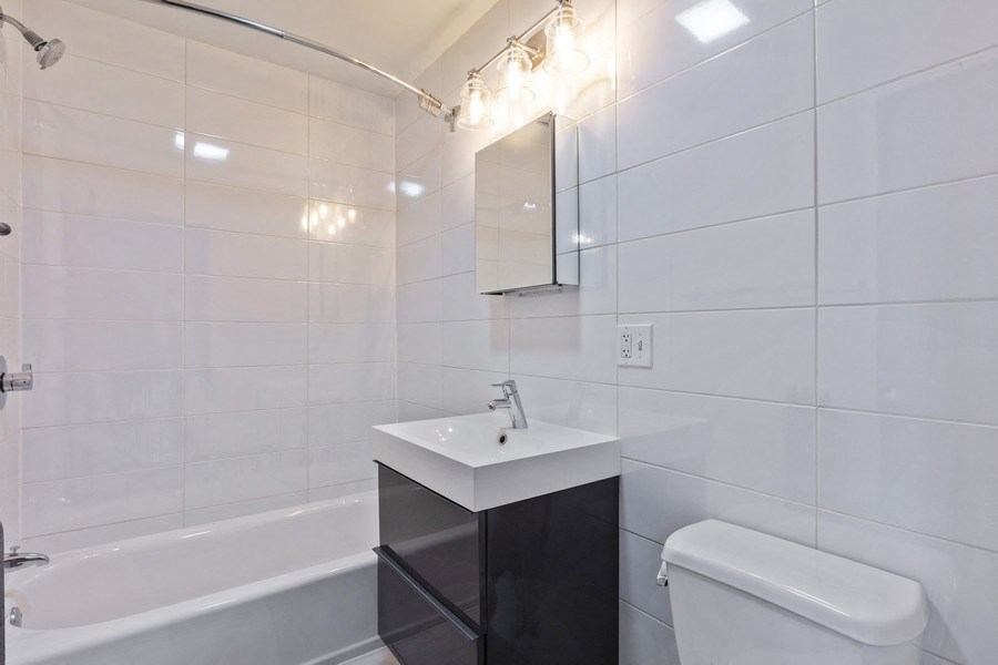 a bathroom with a sink and a toilet and a bath tub