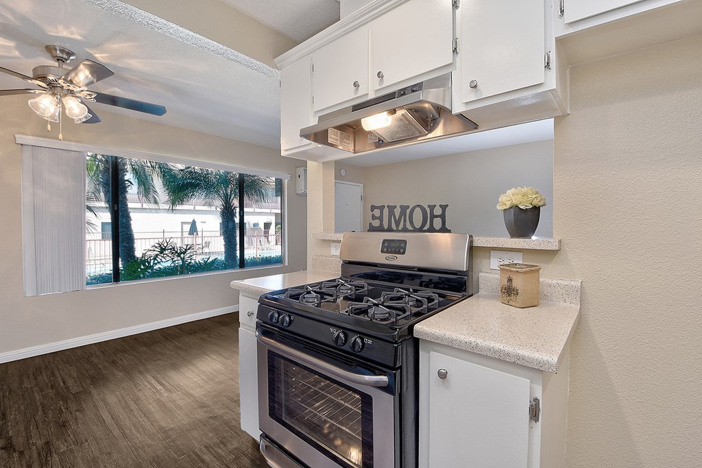 an open kitchen with stainless steel appliances and a large window