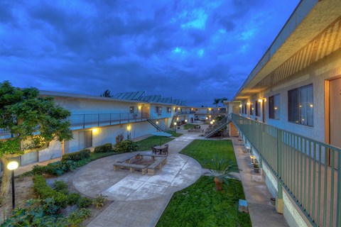 the courtyard of a building with tables and benches