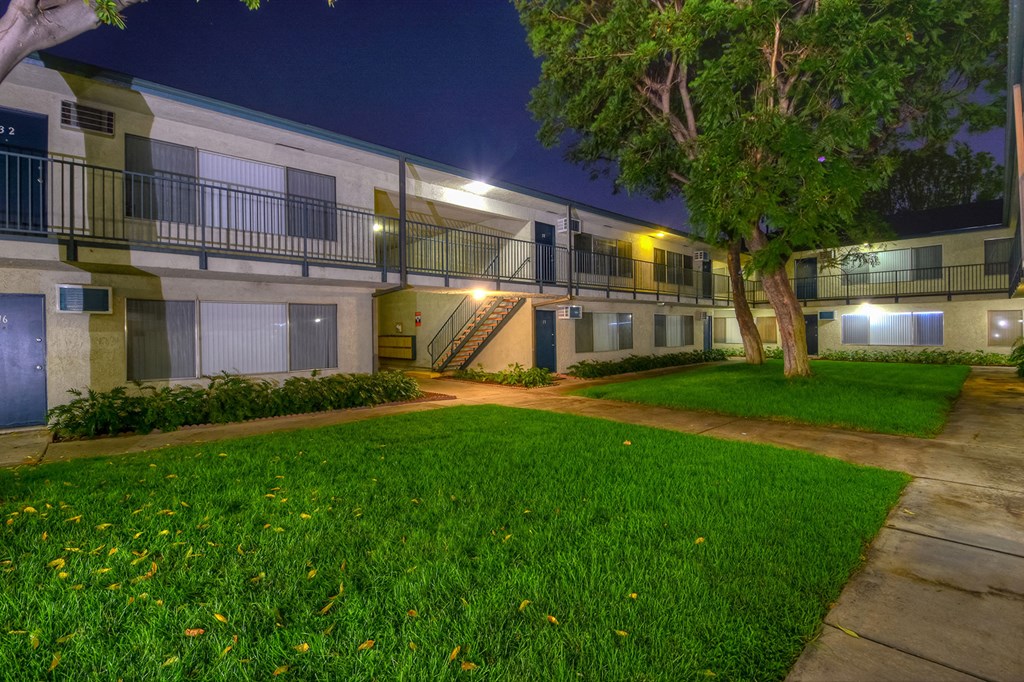 the courtyard of an apartment building at night
