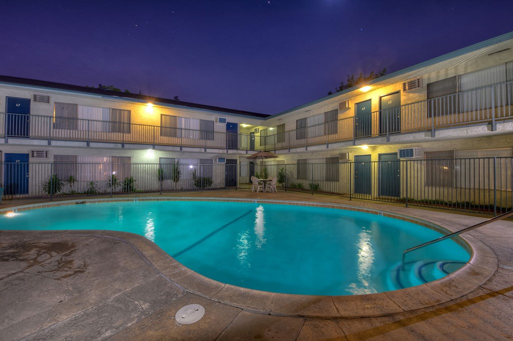 a resort style swimming pool at night