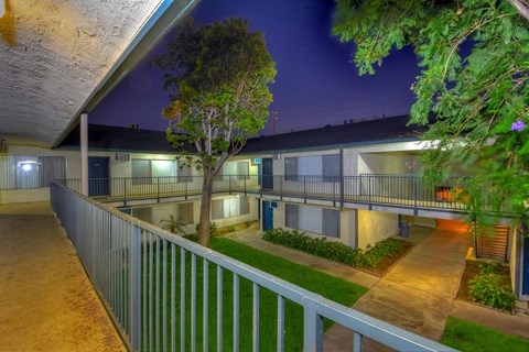 a city at night with buildings and a courtyard