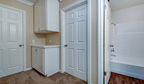 a bedroom with white doors and a closet