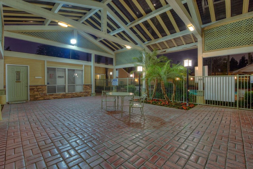 a courtyard with tables and chairs outside of a building