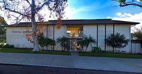 a white building with a sidewalk in front of it