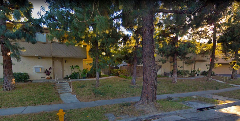 a neighborhood with trees and a yellow house