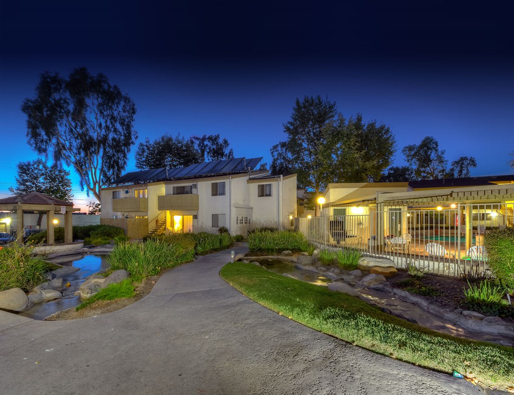 the yard of a home is lit up at night