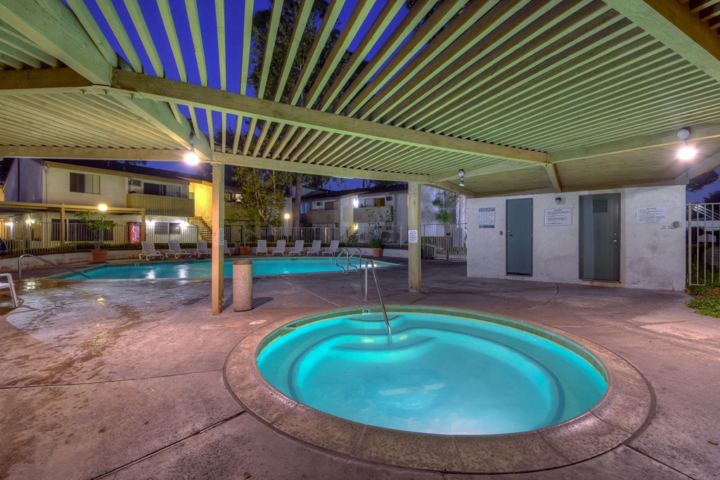 a swimming pool with a hot tub and a pool