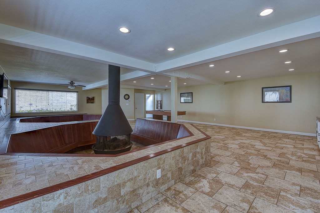 a large living room with a fireplace and a seating area