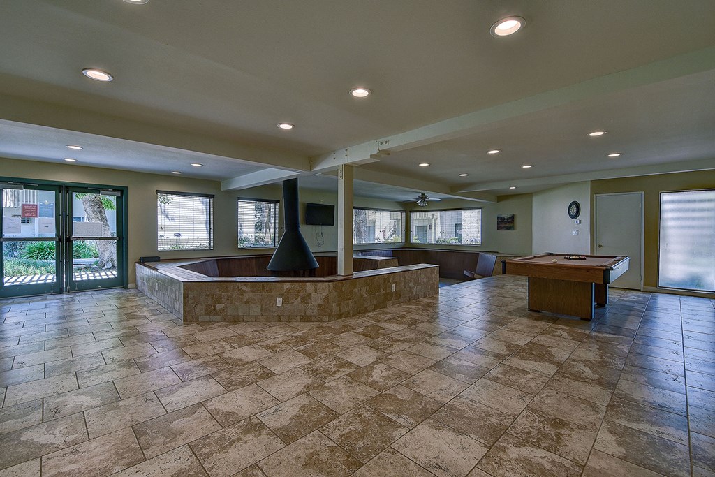 a game room with a pool table and a bar