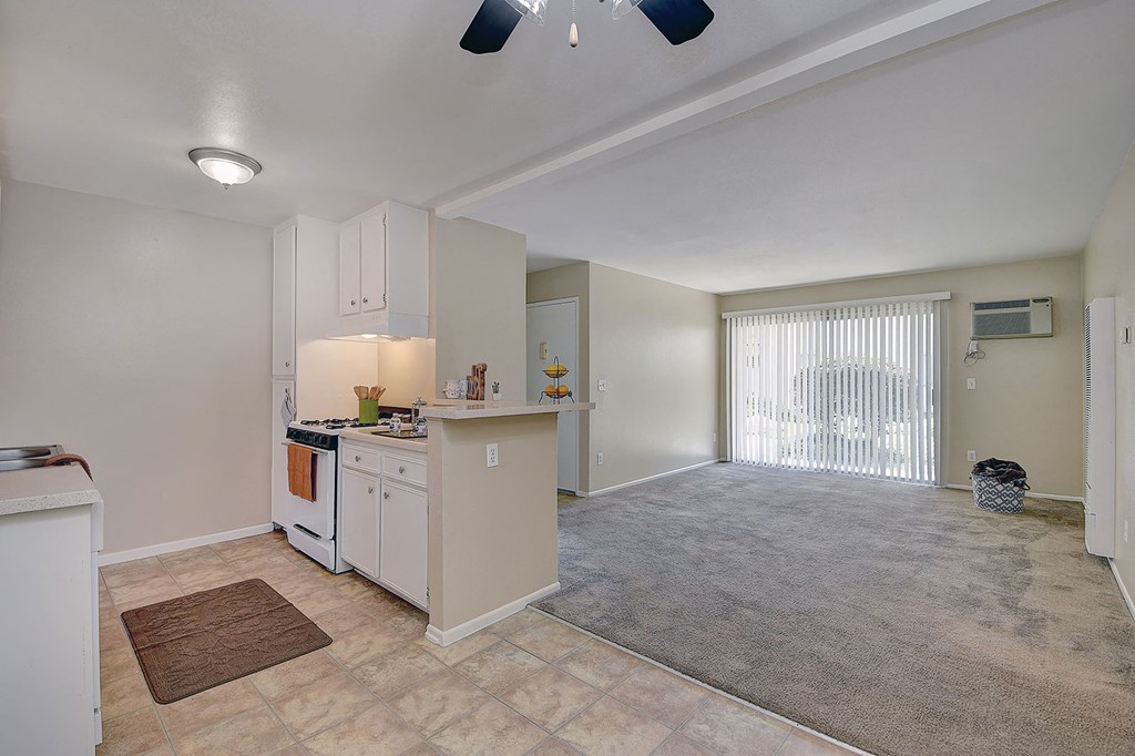 an empty kitchen and living room with a large window