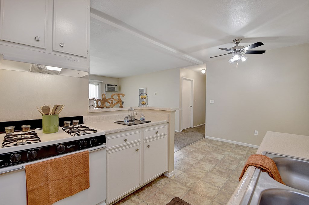 a kitchen with a stove top oven and a sink