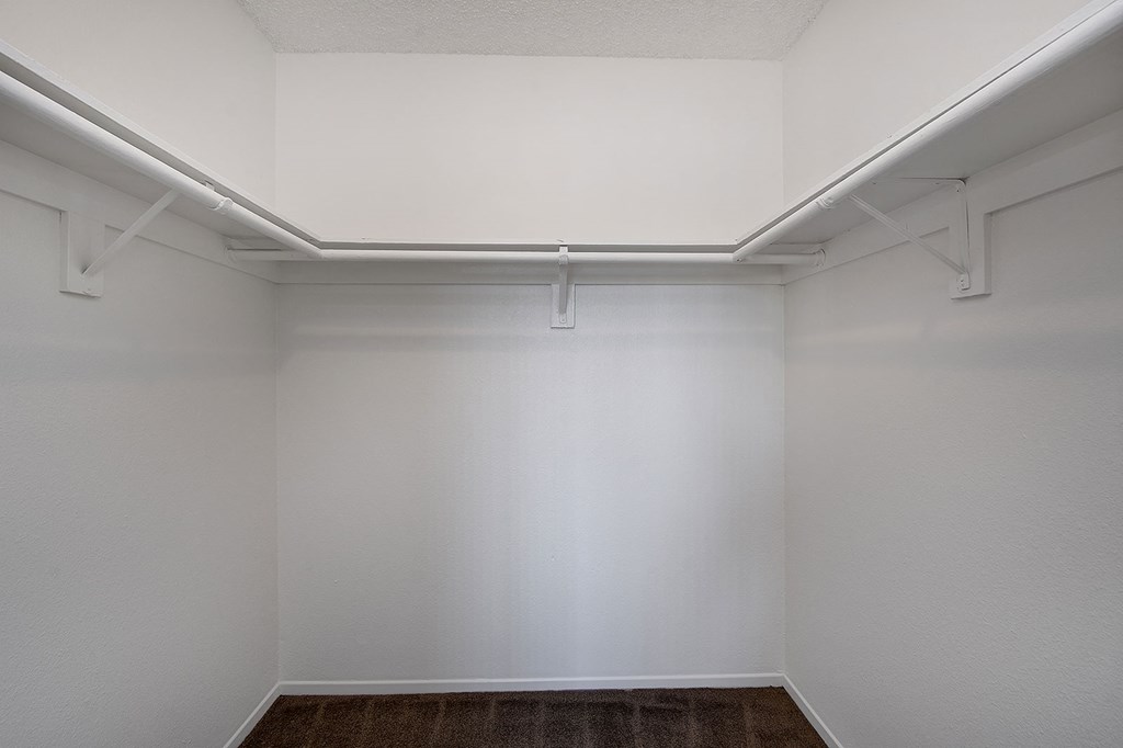 an empty white room with white walls and a brown carpet