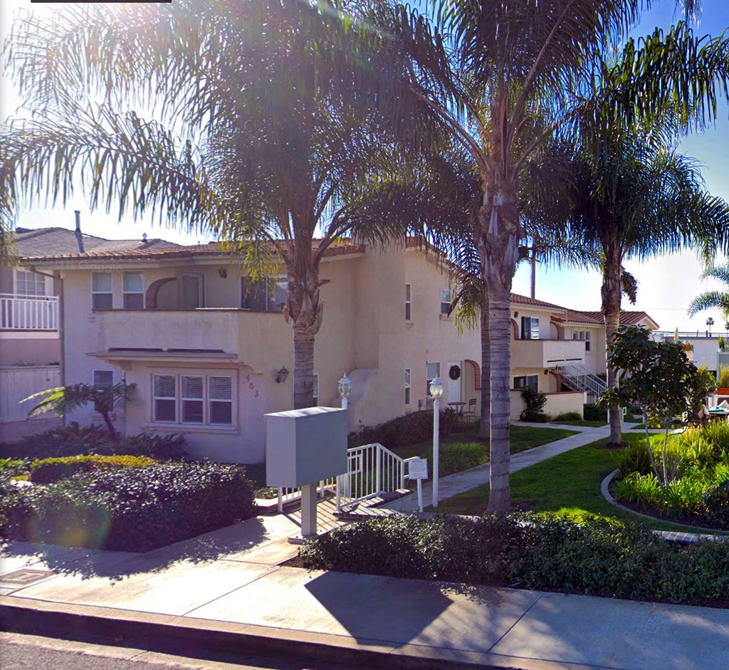 a house with palm trees in front of it