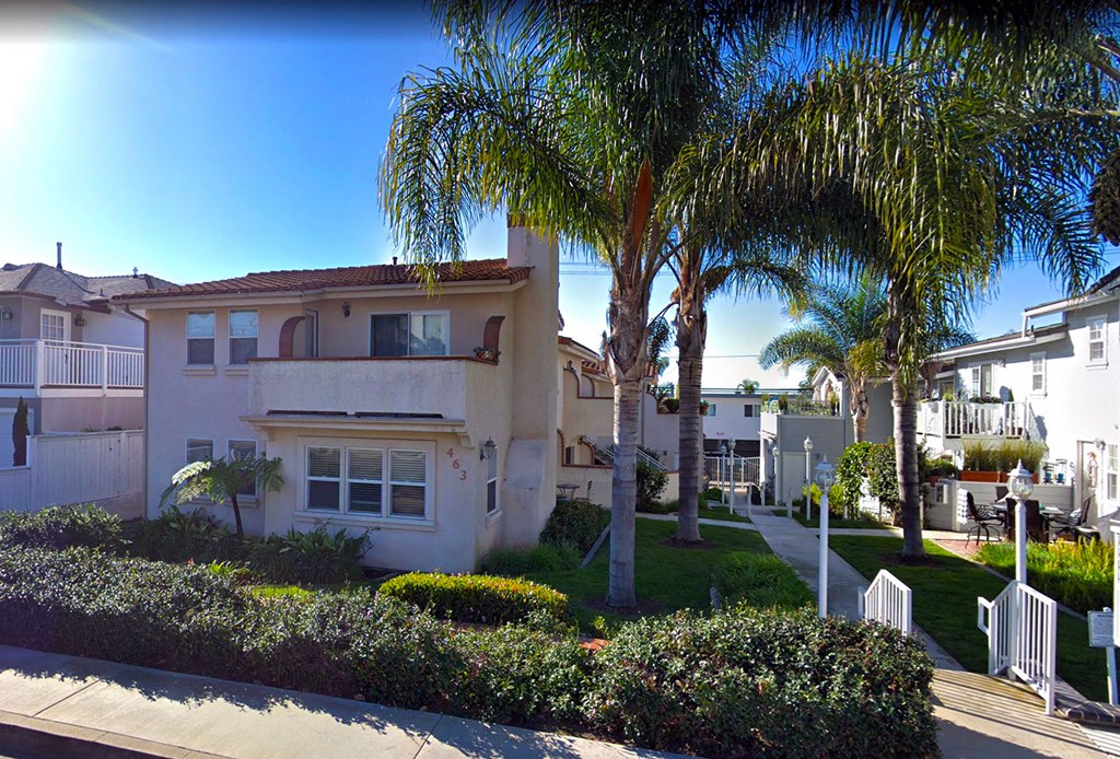 a house with palm trees in front of it