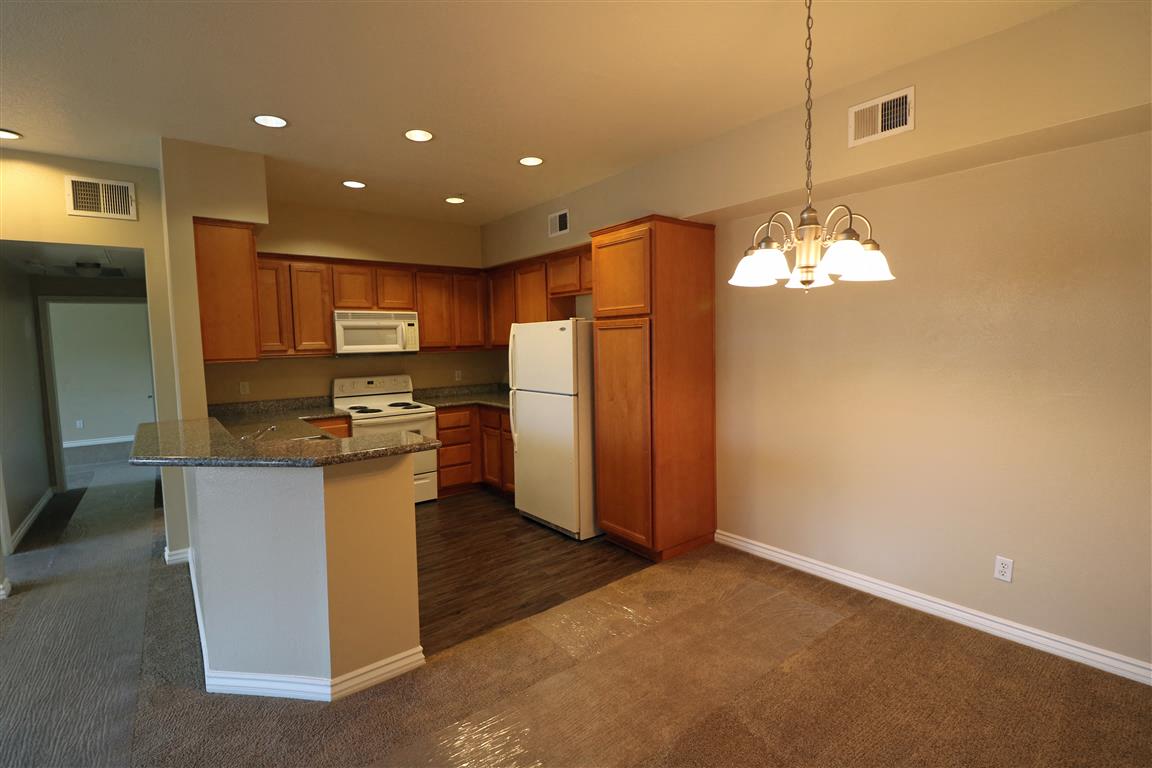 a kitchen with a counter top and a refrigerator