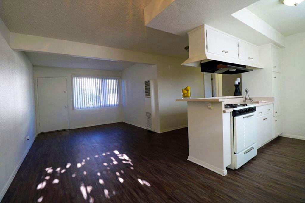 an empty kitchen with a stove and a sink